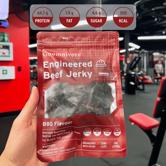 Engineered Beef jerky package shot in the gym with nutrtional macros on top.
